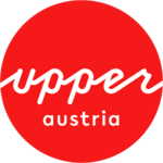 Logo Oberösterreich Tourismus: red circle with white upperaustria lettering